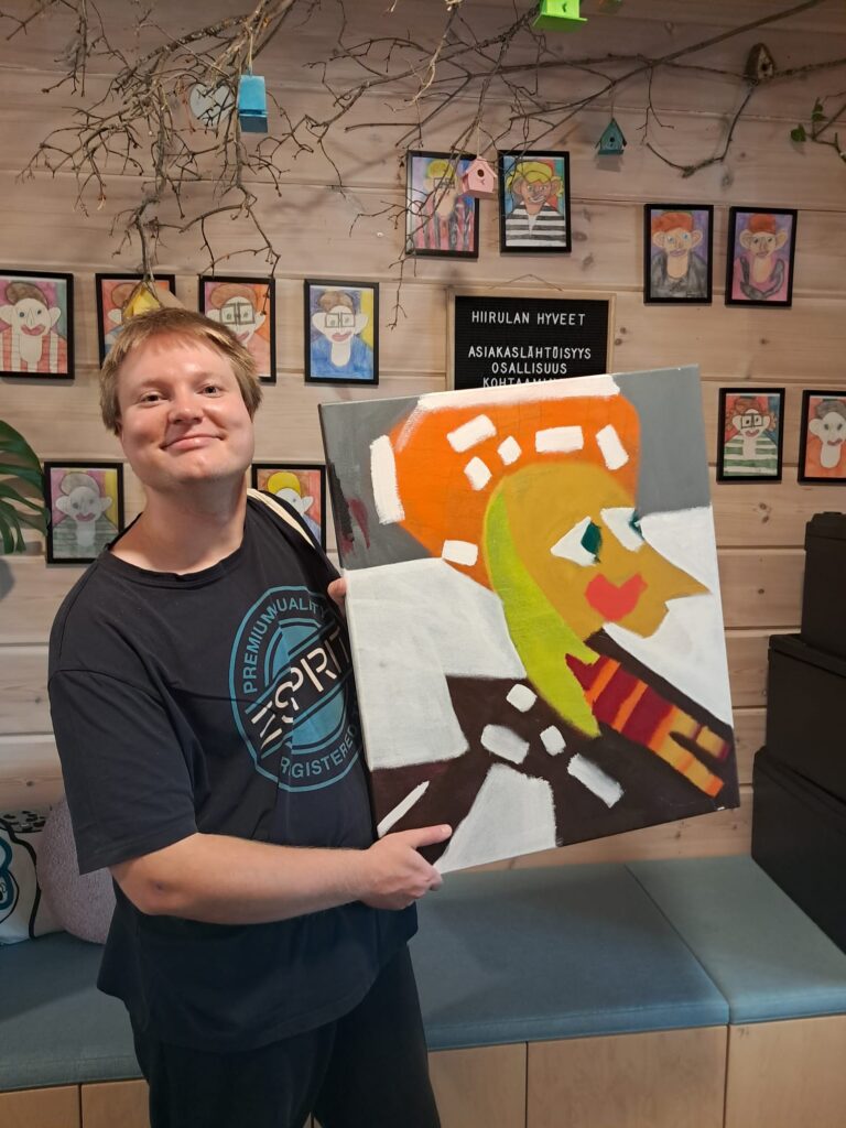 Taiteilija Mikael Valjakka teoksensa kanssa.